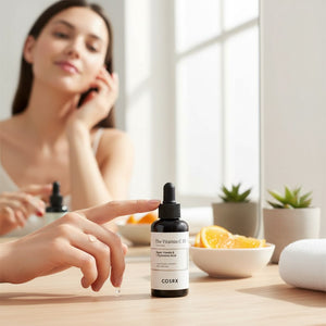 Skin TOGO COSRX The Vitamin C 13 Serum bottle on a wooden table with a woman in the background