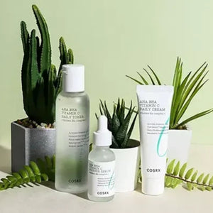 Skin TOGO COSRX AHA BHA Vitamin C skincare set including toner, booster serum, and daily cream with green plants.