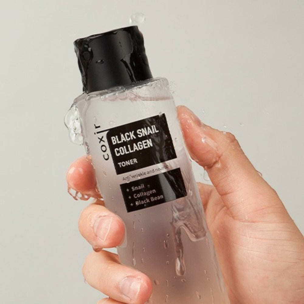 Skin TOGO Coxir Black Snail Collagen Toner bottle held in hand with refreshing water droplets on the packaging
