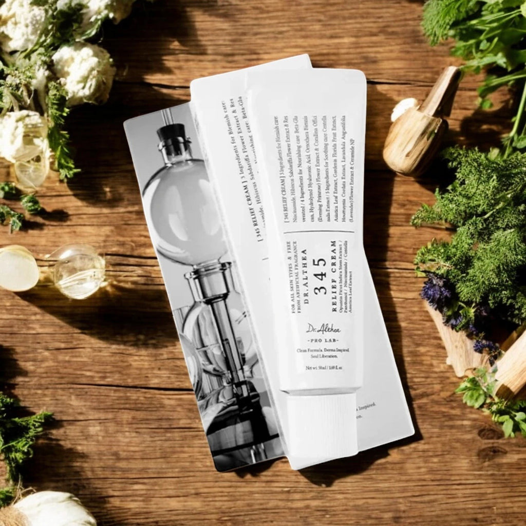 Skin TOGO Dr.Althea 345 Relief Cream tube and box on a wooden table with fresh herbs and flowers