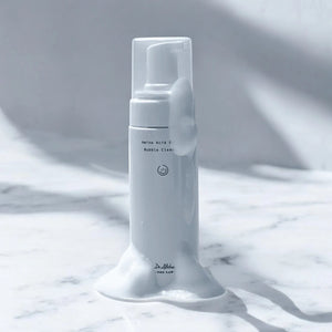 Skin TOGO Dr.Althea Amino Acid Gentle Bubble Cleanser bottle with rich white foam on a marble surface.