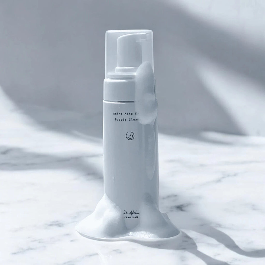 Skin TOGO Dr.Althea Amino Acid Gentle Bubble Cleanser bottle with rich white foam on a marble surface.