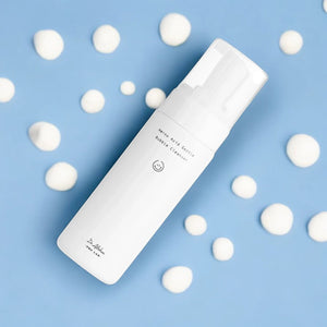 Skin TOGO Dr.Althea Amino Acid Gentle Bubble Cleanser in a white bottle surrounded by creamy foam on a blue background
