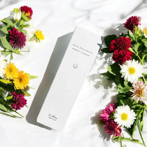 Skin TOGO Dr.Althea Amino Acid Gentle Bubble Cleanser box surrounded by colorful flowers on a white background.