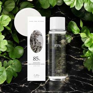 Skin TOGO Dr.Althea Anastatica Skin Conditioning Toner bottle and box on a black marble surface with green leaves.