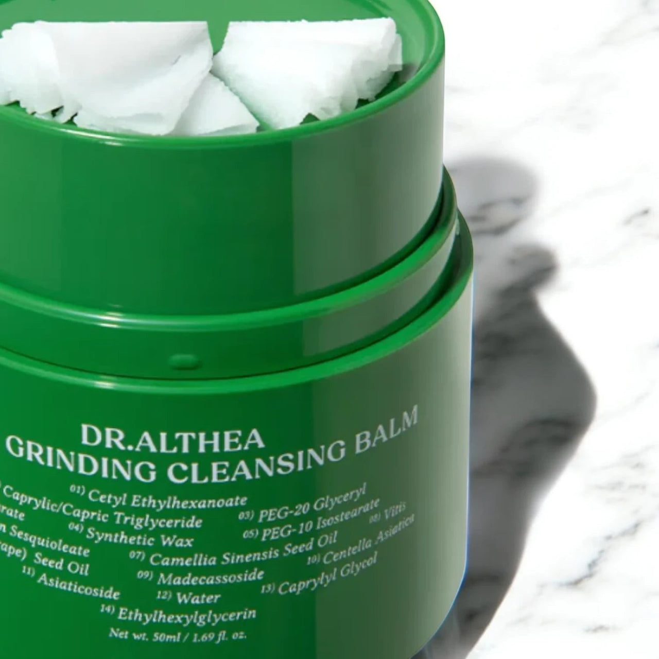 Skin TOGO Dr.Althea Pure Grinding Cleansing Balm in a green jar with white product dispensed on top