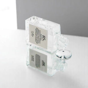 Skin TOGO Dr. Althea Natural Radiance Essence serum bottle pouring clear liquid on a reflective surface