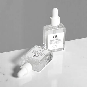 Skin TOGO Dr. Althea Natural Radiance Essence serum bottles with dropper caps on a white marble surface.