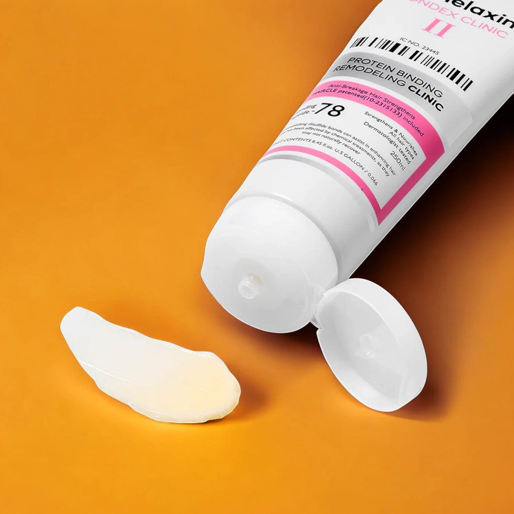 Skin TOGO Dr.Melaxin Bondex Protein Bonding Remodeling Clinic hair conditioner tube with a dollop of cream on orange