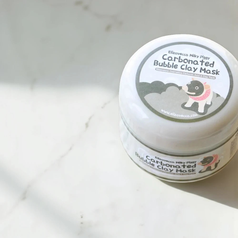 Skin TOGO Elizavecca Milky Piggy Carbonated Bubble Clay Mask in a white jar on a marble surface.