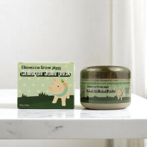 Skin TOGO Elizavecca Green Piggy Collagen Jella Pack hydrating face mask jar and packaging box on a marble surface.