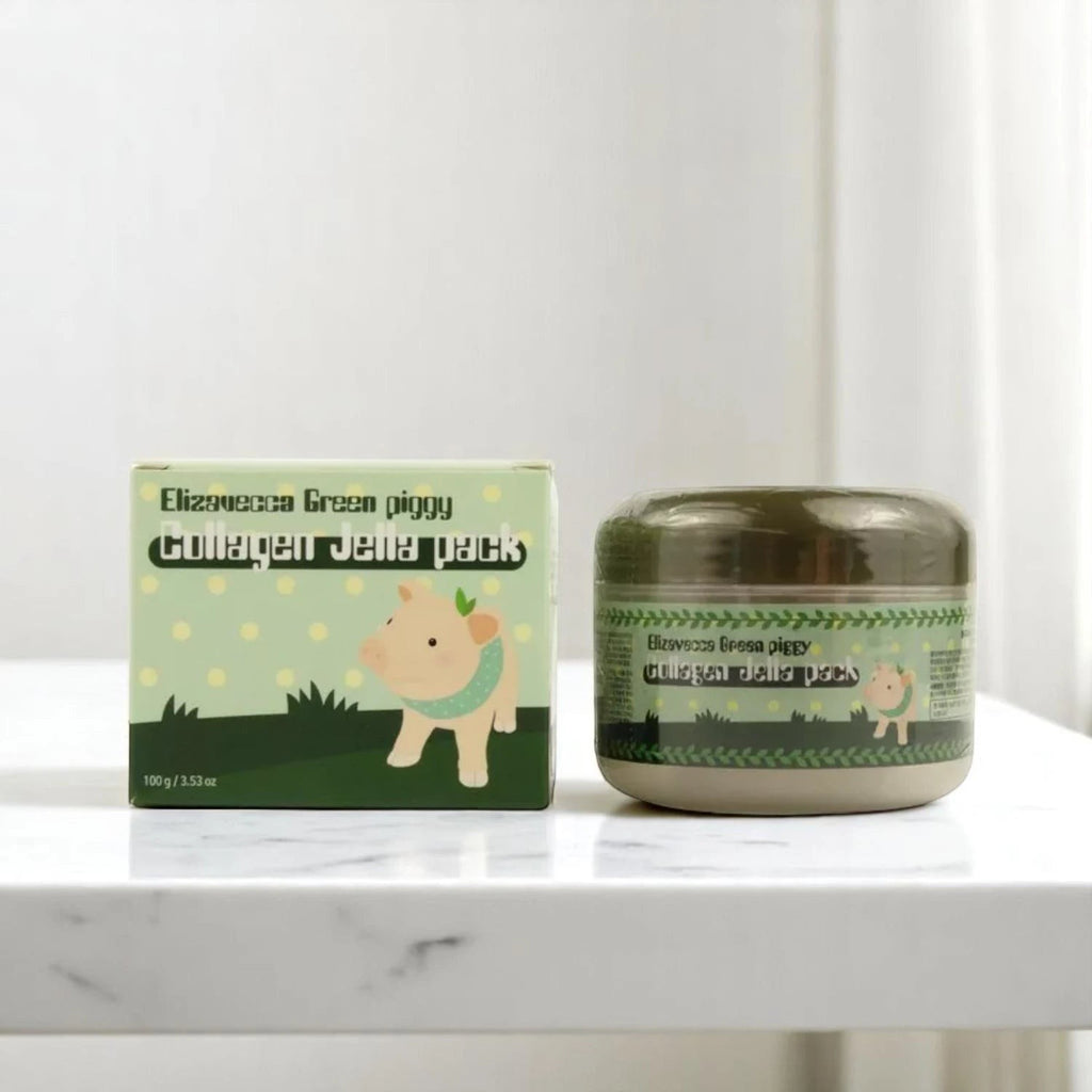 Skin TOGO Elizavecca Green Piggy Collagen Jella Pack hydrating face mask jar and packaging box on a marble surface.
