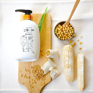 Skin TOGO Elizavecca CER-100 Collagen Coating Hair A+ Muscle Shampoo bottle with natural ingredients on a wooden board.