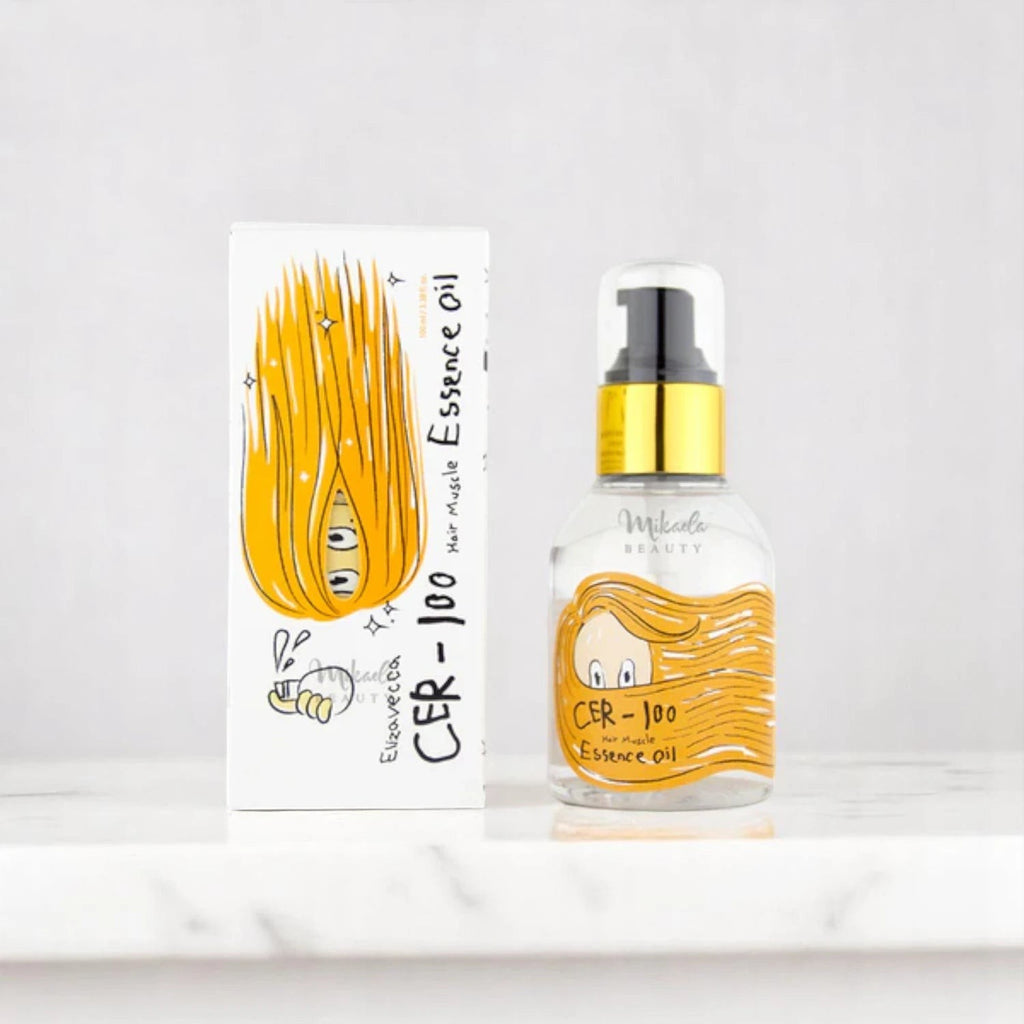 Skin TOGO Elizavecca CER-100 Hair Muscle Essence Oil bottle and box with cartoon hair illustration on marble surface