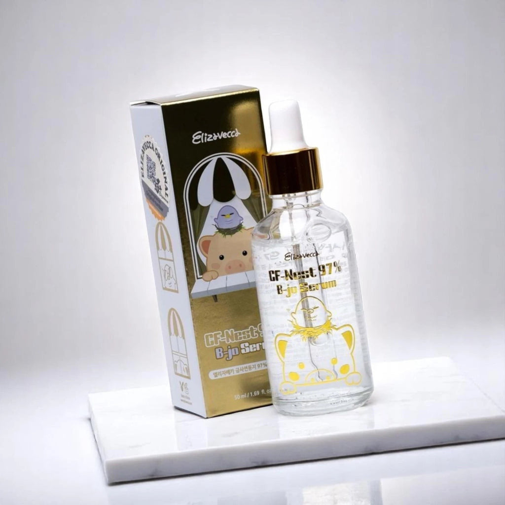 Skin TOGO Elizavecca CF-Nest 97% B-jo Serum bottle and gold box on a white marble surface for deep skin hydration.