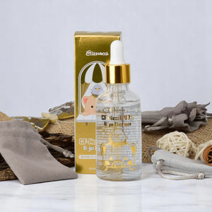 Skin TOGO Elizavecca CF-Nest 97% B-jo serum in a glass dropper bottle with its gold packaging box on a marble surface.