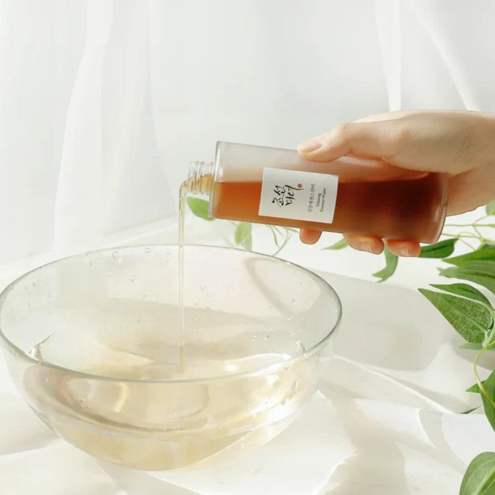 Skin TOGO Beauty of Joseon Ginseng Essence Water being poured from a glass bottle into a clear bowl