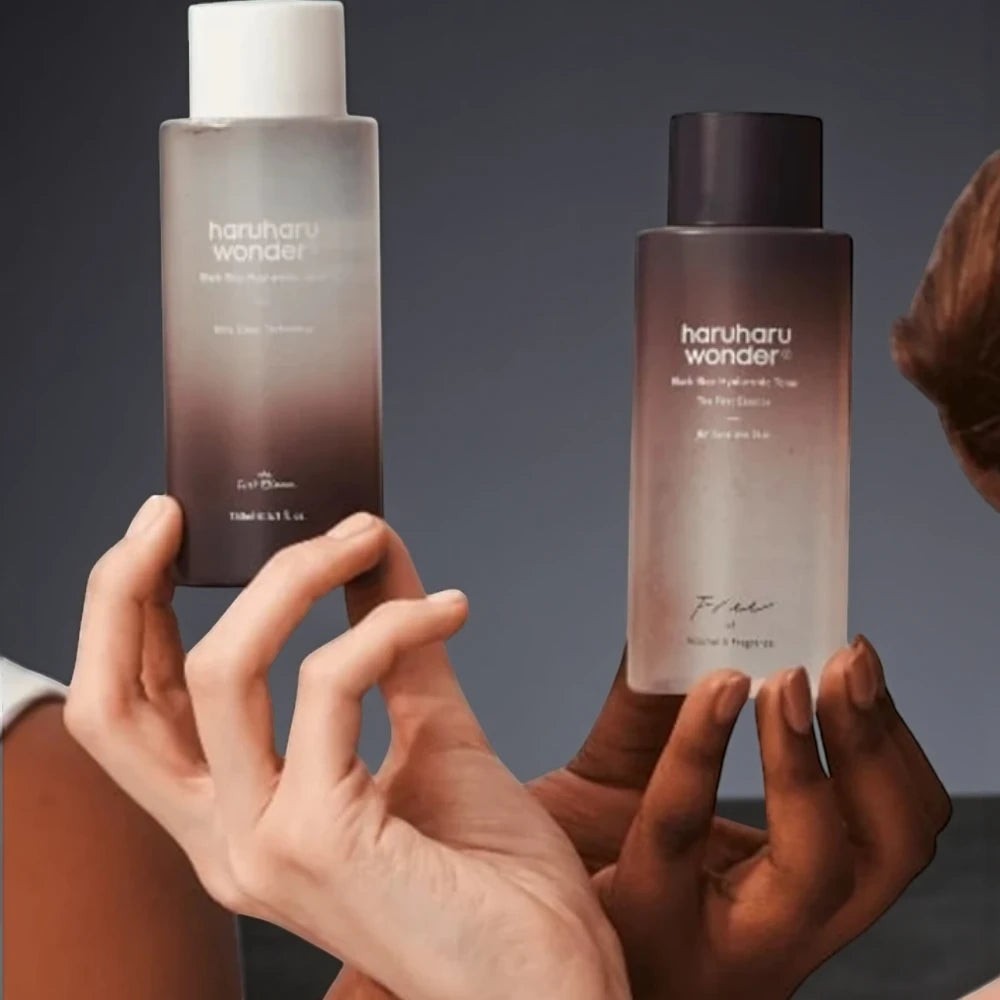 Skin TOGO Haruharu WONDER Black Rice Hyaluronic Toner bottles held by two hands with different skin tones