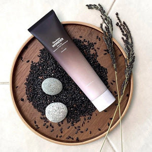 Skin TOGO Haruharu WONDER Black Rice Moisture 5.5 Soft Cleansing Gel tube on a wooden tray with black rice grains.