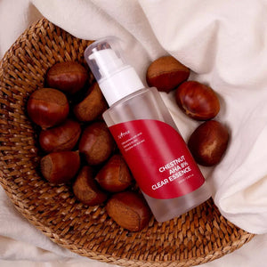 Skin TOGO Isntree Chestnut AHA 8% Clear Essence bottle in a woven basket surrounded by fresh chestnuts.