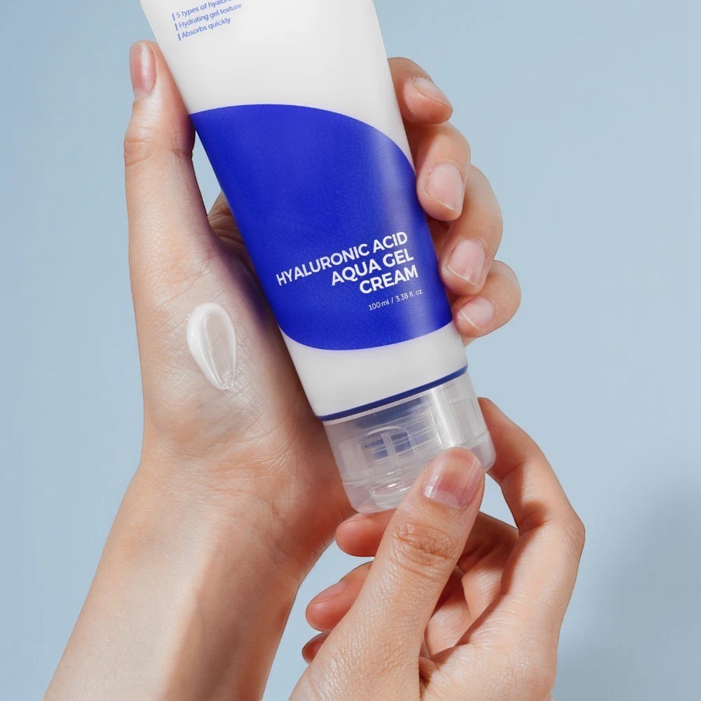Skin TOGO Isntree Hyaluronic Acid Aqua Gel Cream tube held in hand with a swatch of the lightweight white gel texture