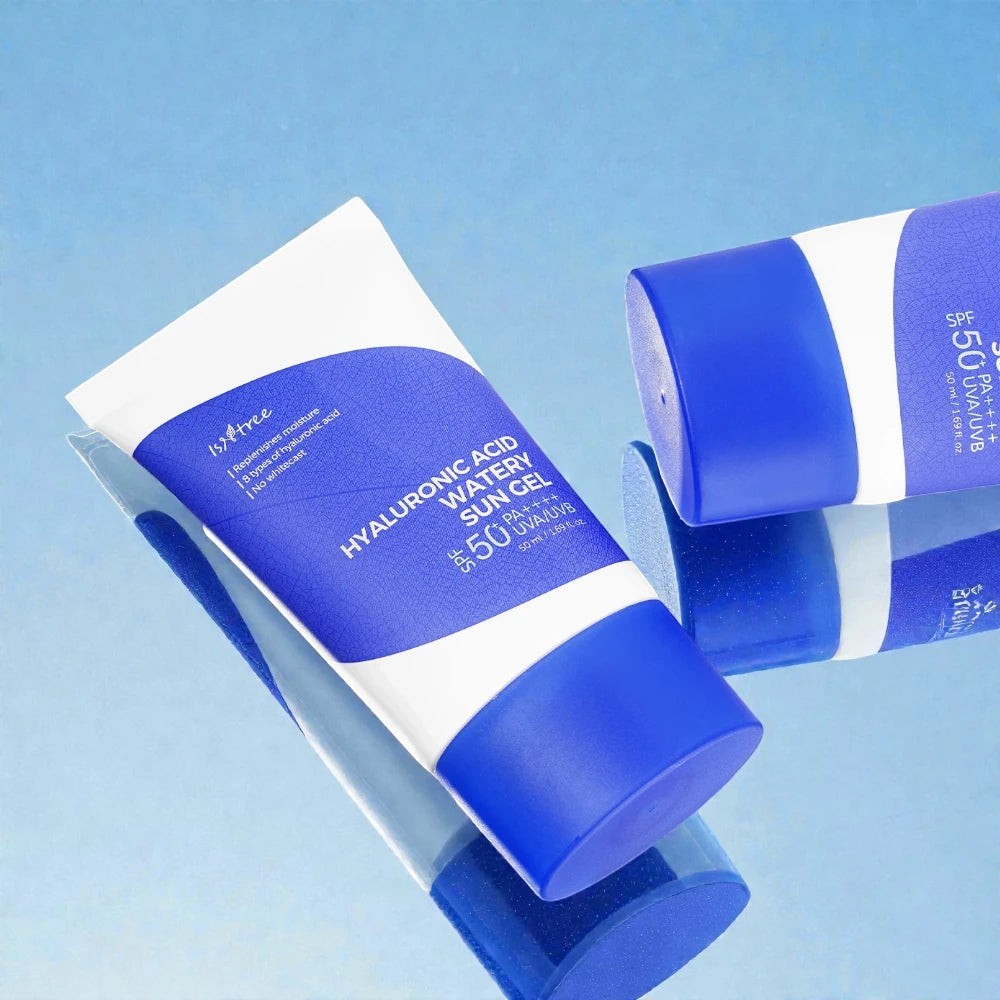 Skin TOGO Isntree Hyaluronic Acid Watery Sun Gel SPF 50+ tubes on a reflective blue surface.