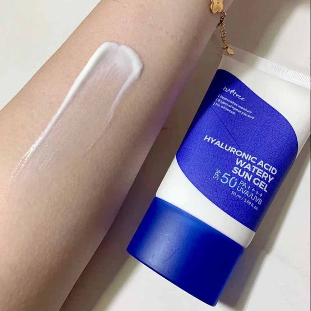 Skin TOGO Isntree Hyaluronic Acid Watery Sun Gel SPF50+ tube with a white cream swatch on a person's arm.