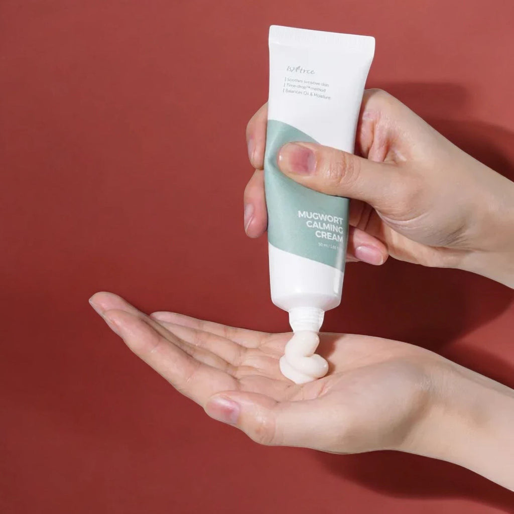 Skin TOGO Isntree Mugwort Calming Cream squeezed onto a hand, showing the lightweight white gel-cream texture.