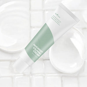 Skin TOGO Isntree Mugwort Calming Cream in a white and sage green tube on a white tiled background.