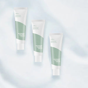 Skin TOGO Isntree Mugwort Calming Cream tubes with green accents for sensitive skin care on a soft blue background.