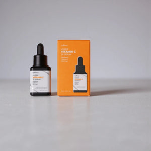 Skin TOGO Isntree Hyper Vitamin C23 serum bottle and orange box on a neutral surface for brightening skin care