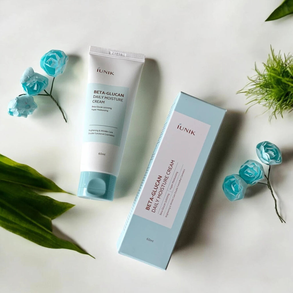 Skin TOGO iUNIK Beta Glucan Daily Moisture Cream tube and box with light blue packaging on a white surface.