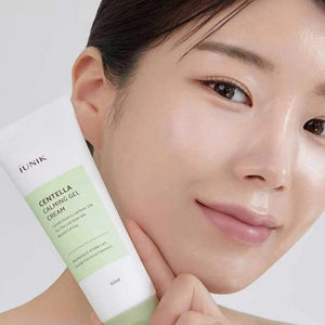Skin TOGO iUNIK Centella Calming Gel cream held by a woman with glowing skin, showing the 60ml tube packaging.
