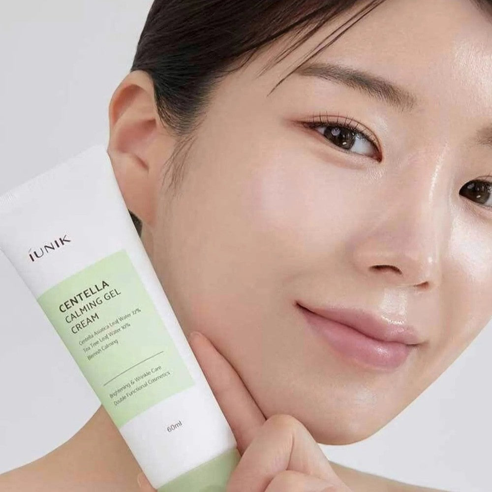 Skin TOGO iUNIK Centella Calming Gel cream held by a woman with glowing skin, showing the 60ml tube packaging.