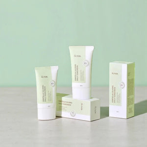 Skin TOGO iUNIK Centella Calming Sun Cream tubes and packaging on a light surface against a soft green background.