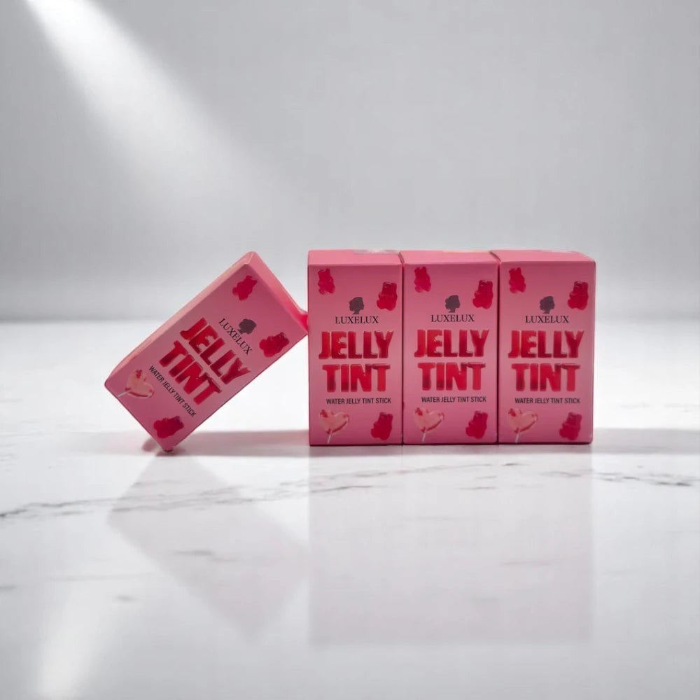Skin TOGO Luxelux Jelly Tint Stick boxes in light pink with gummy bear illustrations on a white marble surface.