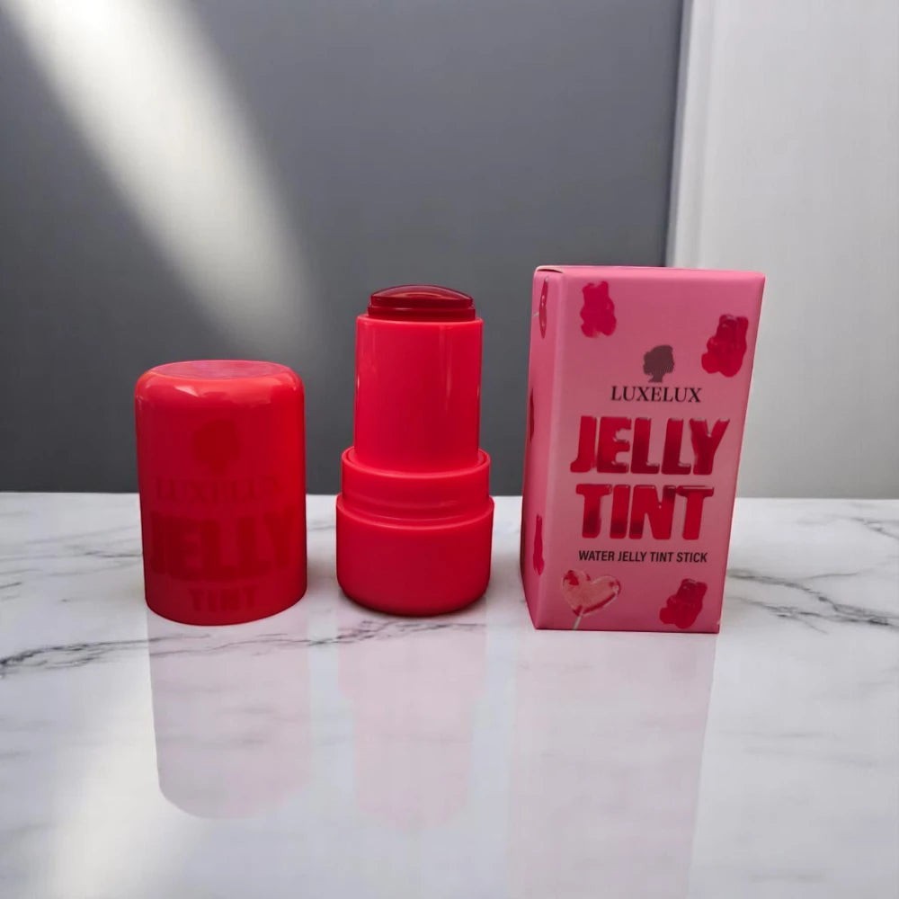 Skin TOGO Luxelux Jelly Tint Stick in Light Pink 01 with its pink packaging and open applicator on a marble surface.