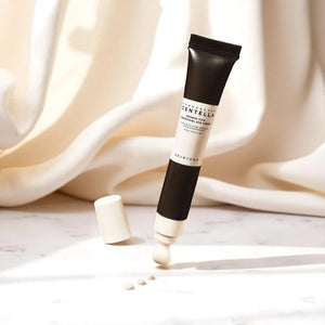 Skin TOGO Madagascar Centella Probio-Cica Bakuchiol Eye Cream tube with dispensed cream on a white marble surface.