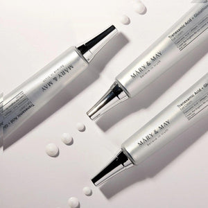 Skin TOGO Mary&May Tranexamic Acid + Glutathione eye cream tubes with cream drops on a white background.