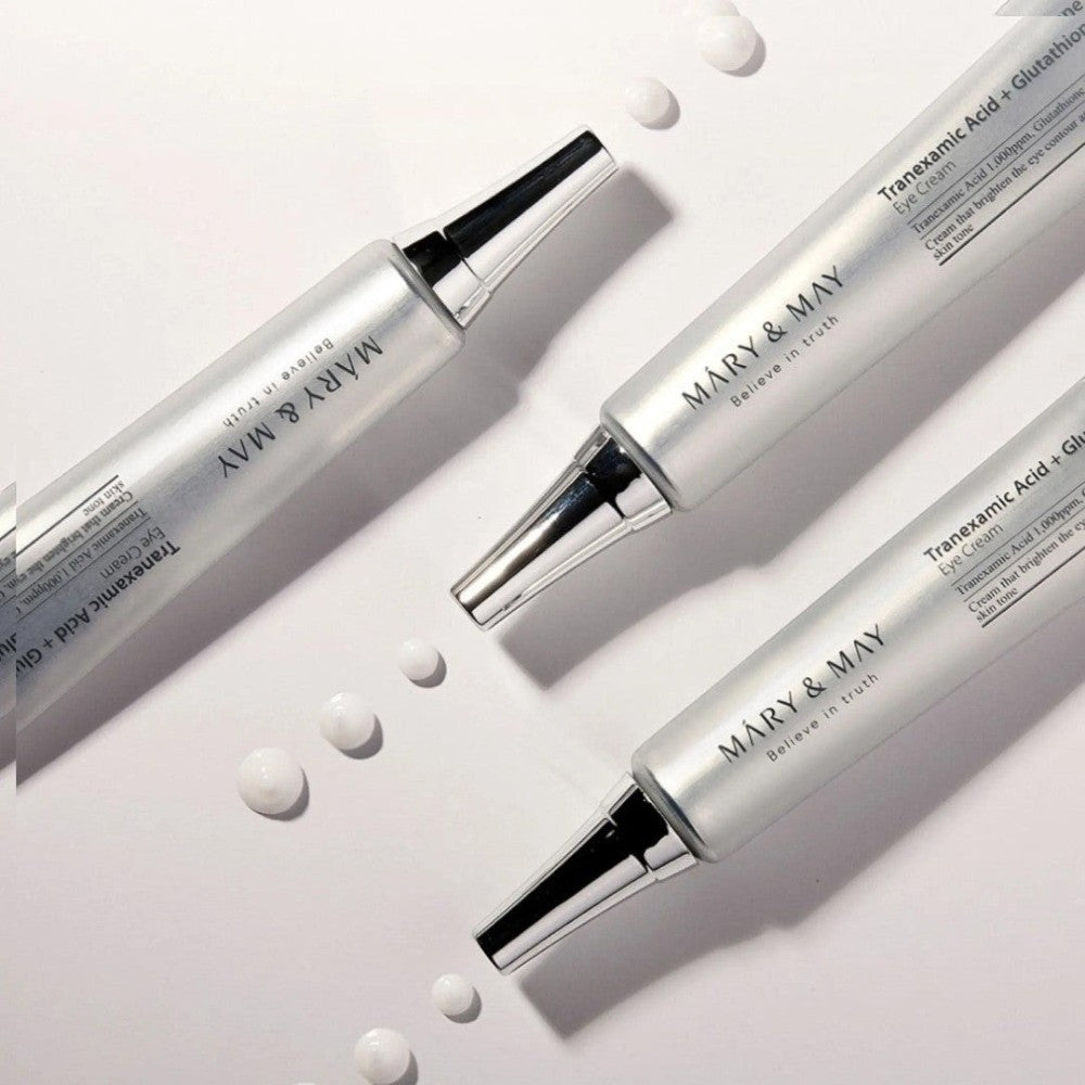 Skin TOGO Mary&May Tranexamic Acid + Glutathione eye cream tubes with cream drops on a white background.