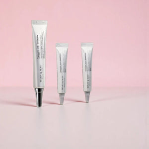 Skin TOGO Mary&May Tranexamic Acid + Glutathione eye cream tubes in varying sizes on a soft pink background.