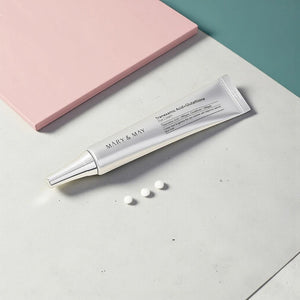 Skin TOGO Mary&May Tranexamic Acid + Glutathione eye cream tube with three cream dots on a minimalist surface.