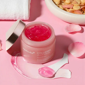 Skin TOGO Medicube Collagen Jelly Cream in a pink jar with a bouncy, translucent pink gel texture and a small spatula.