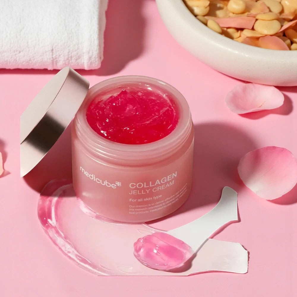 Skin TOGO Medicube Collagen Jelly Cream in a pink jar with a bouncy, translucent pink gel texture and a small spatula.
