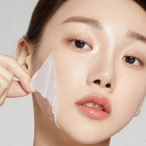 Skin TOGO Medicube Collagen Night Wrapping Mask being peeled off a model's face for firming and hydrating skincare