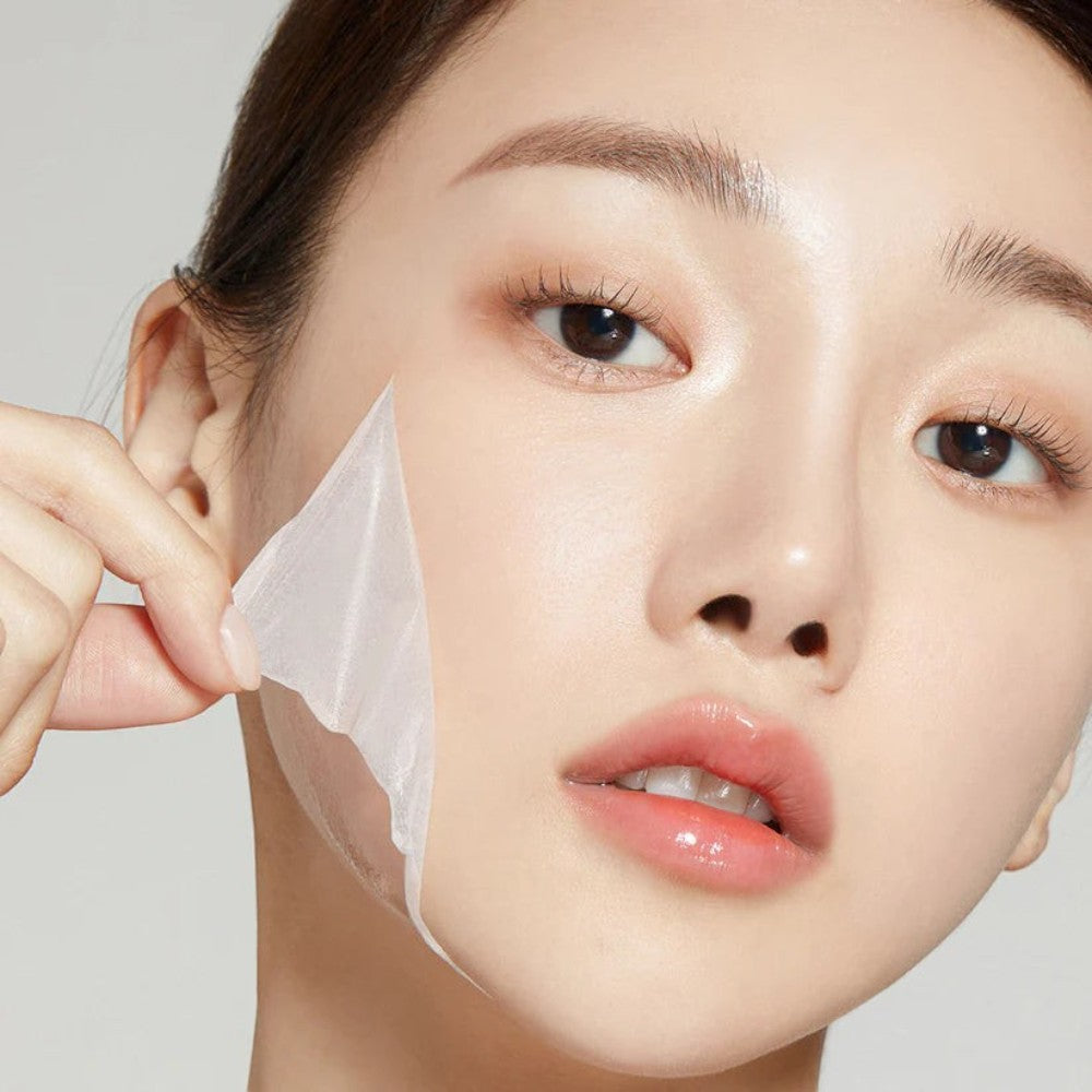 Skin TOGO Medicube Collagen Night Wrapping Mask being peeled off a model's face for firming and hydrating skincare