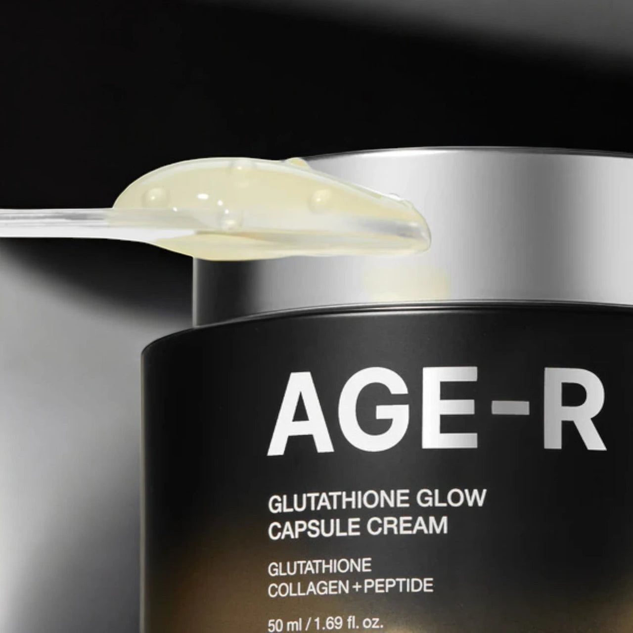 Skin TOGO Medicube AGE-R Glutathione Glow Capsule Cream with a clear spatula showing the textured cream formula