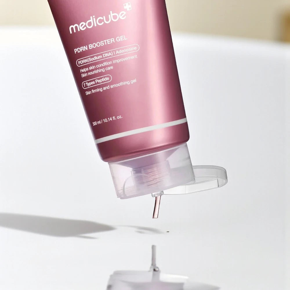 Skin TOGO Medicube PDRN Booster Gel in a metallic pink tube dispensing a clear, lightweight hydrating gel formula.