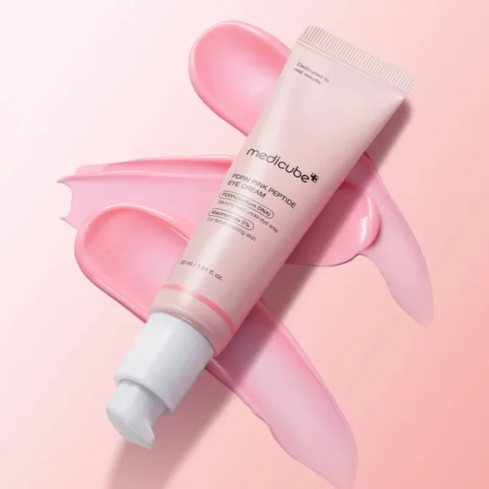 Skin TOGO Medicube PDRN Pink Peptide Eye Cream in a 30ml tube with smooth pink cream swatches on a soft background.