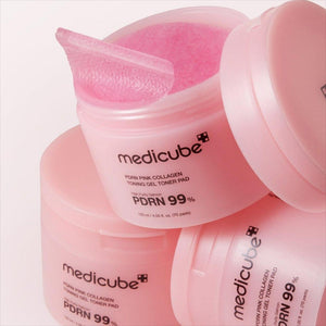 Skin TOGO Medicube PDRN Pink Collagen Toning Gel Toner Pads in a pink jar with a single pad lifted for application.